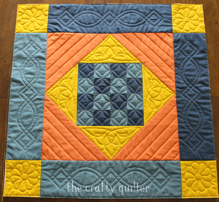 Amish Mini Quilt, a free pattern by Julie Cefalu @ The Crafty Quilter. Includes an option to add applique suitable for the holidays and it's mini charm pack friendly!