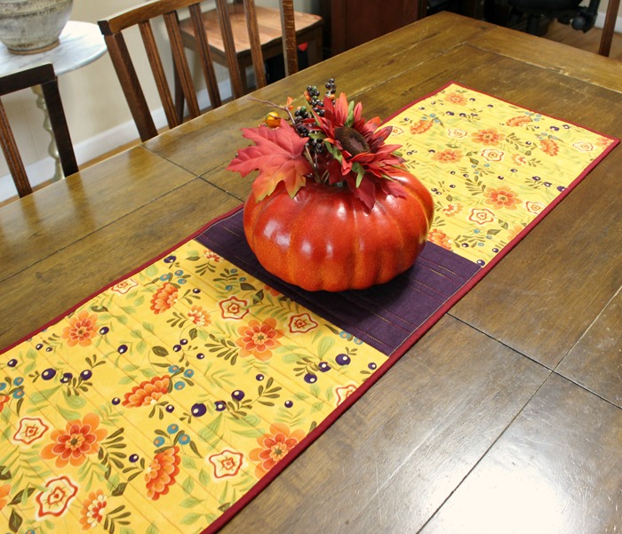 Pumpkin Spice Table Runner made by Julie Cefalu @ The Crafty Quilter. It's a simple design that packs a punch and it's perfect for the Fall holidays.