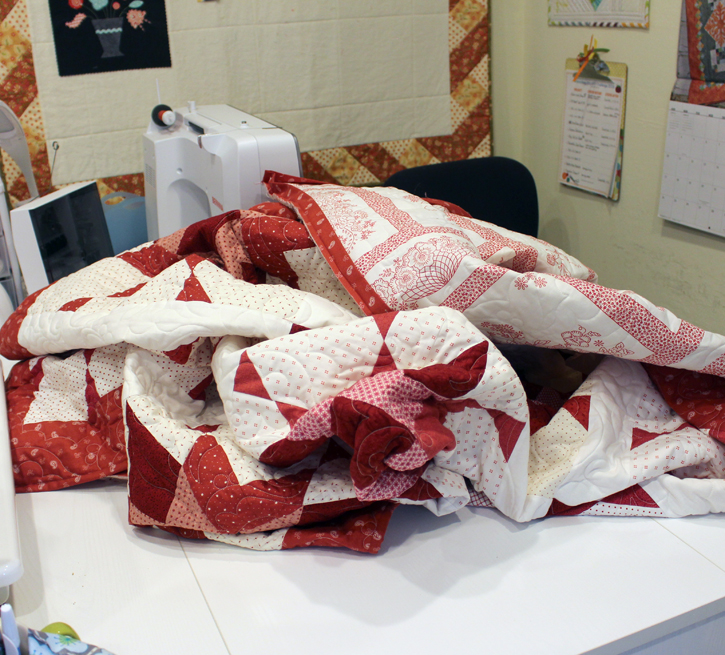 WIP Wednesday, stuck in the binding phase of five quilts!  Julie @ The Crafty Quilter
