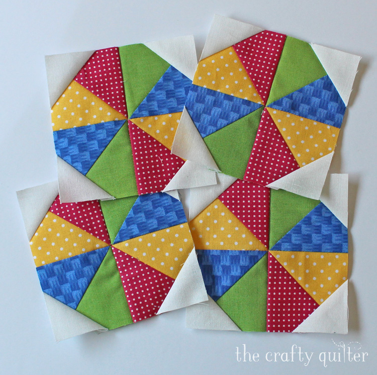 Summer Fun Quilt Along @ The Crafty Quilter features a bright and happy wall hanging that measures 30" x 32". Week 2 instructions include the pinwheel blocks and beach ball blocks.