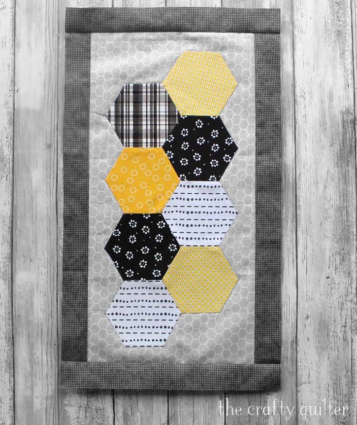 Month 3 of the Save The Bees BOM by Jacquelynne Steves. This block is made by Julie Cefalu @ The Crafty Quilter using machine pieced hexagons and invisible applique.