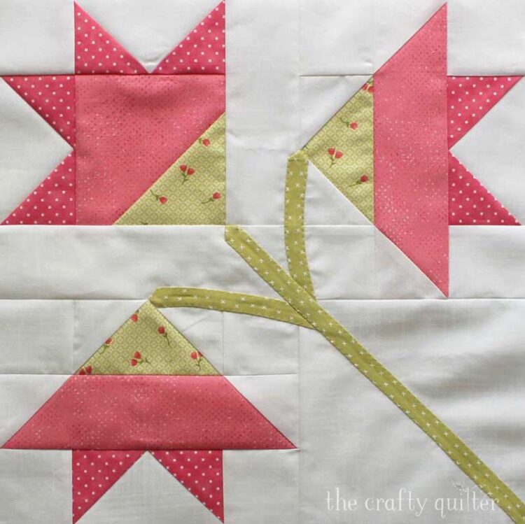 The Carolina Lily Quilt Block is a free block pattern from Fat Quarter Shop that measures 14 1/2" square.  This one is made by Julie Cefalu at The Crafty Quilter.