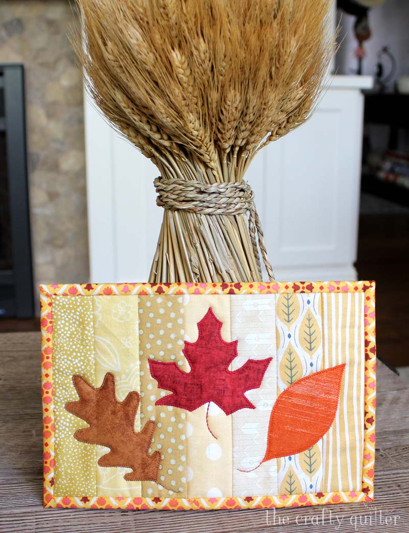 "Quilt As You Go” is a Free Autumn Quilted Mug Rug Pattern designed by Julie Cefalu from The Crafty Quilter!