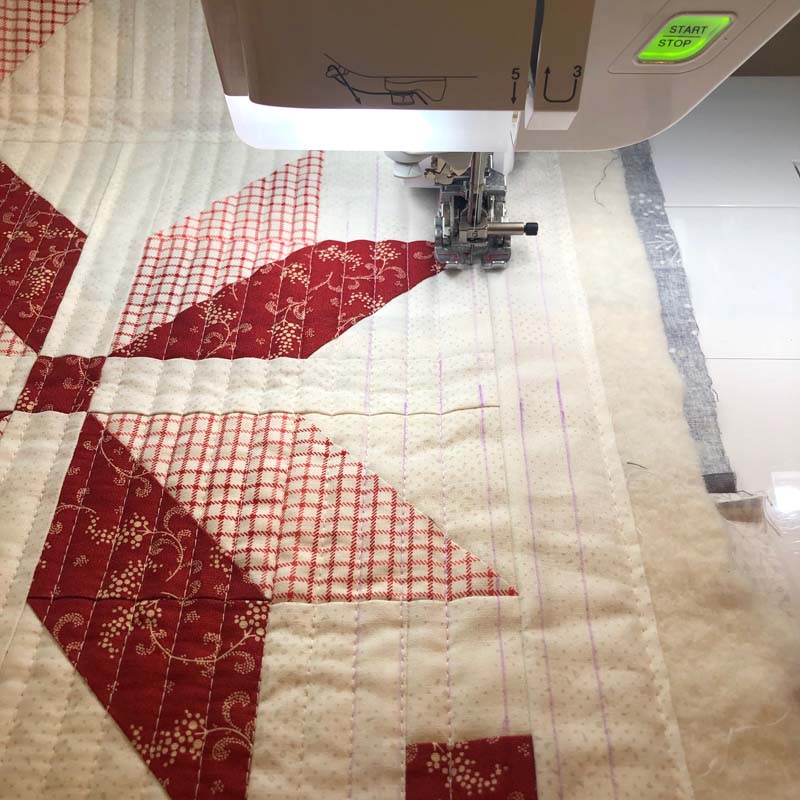 Straight line quilting with parallel lines on the Nordic Star Table Runner by Julie Cefalu @ The Crafty Quilter