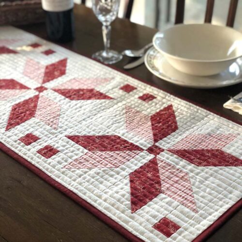 Nordic Star Table Runner features straight line quilting with parallel lines.