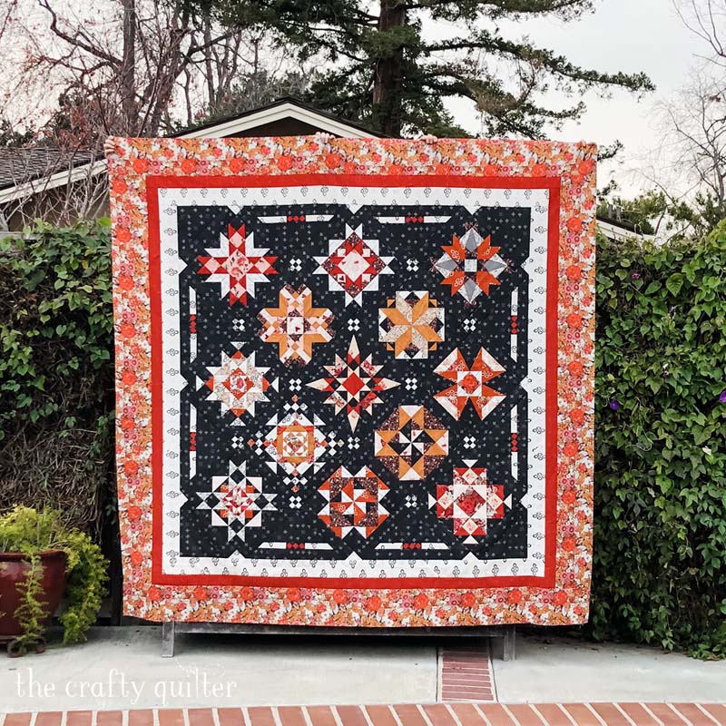 Red at Night 2 quilt made by Julie Cefalu of The Crafty Quilter.  Pattern by Bound to Be Quilting.