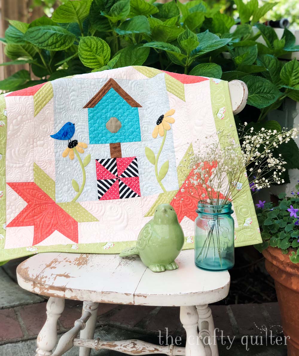 Spring is for The Birds is a 24" square wall hanging.  Free pattern at The Crafty Quilter.