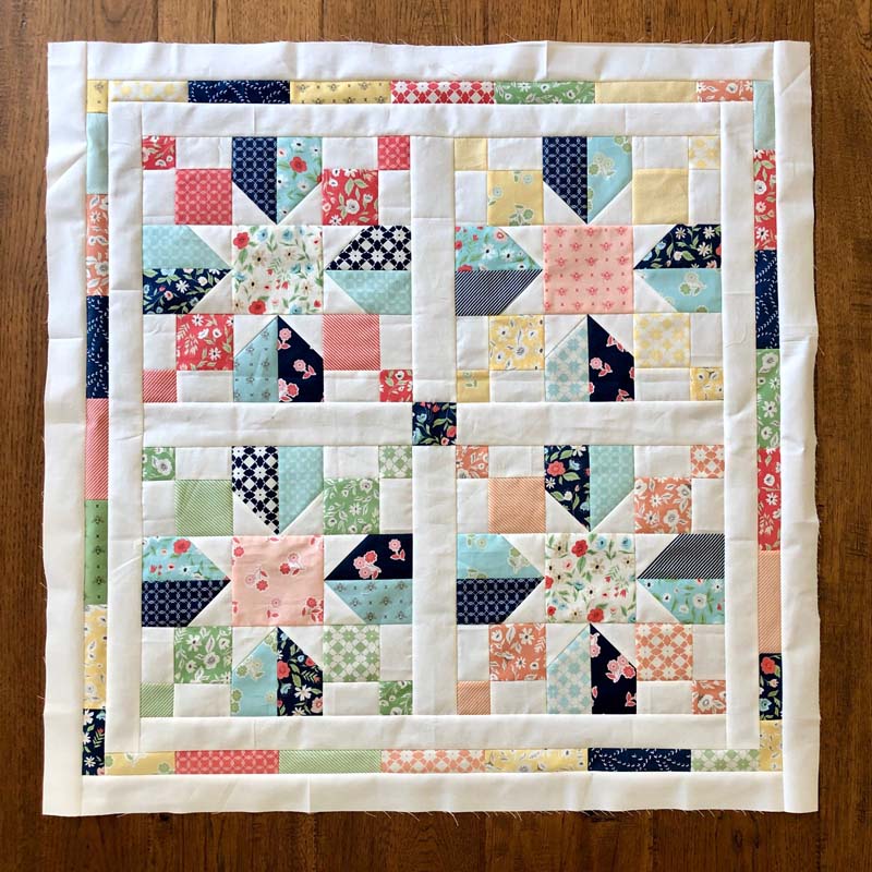 One charm pack and some background fabric was used to make this baby quilt!  A variation of the Vinca Quilt Block Tutorial @ The Crafty Quilter was used for the blocks.