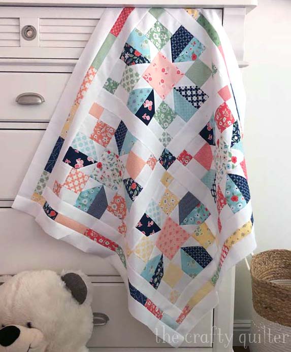 One charm pack and some background fabric was used to make this baby quilt!  A variation of the Vinca Quilt Block Tutorial @ The Crafty Quilter was used for the blocks.