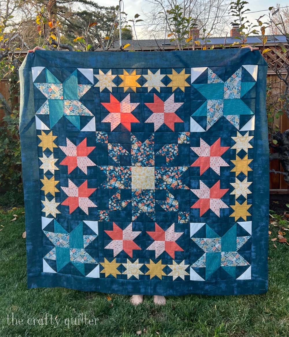 Simply Stars QAL final week includes the finishing instructions to make this beautiful 64" square quilt.  Hosted by Fat Quarter Shop.  This version was made by Julie Cefalu @ The Crafty Quilter using half yards of fabric from the Nutmeg collection by Basic Grey for Moda Fabrics.