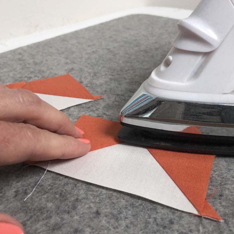 Pressing tips for bulky seams include using a wool pressing mat. See how to press bulky seams flat @ The Crafty Quilter.