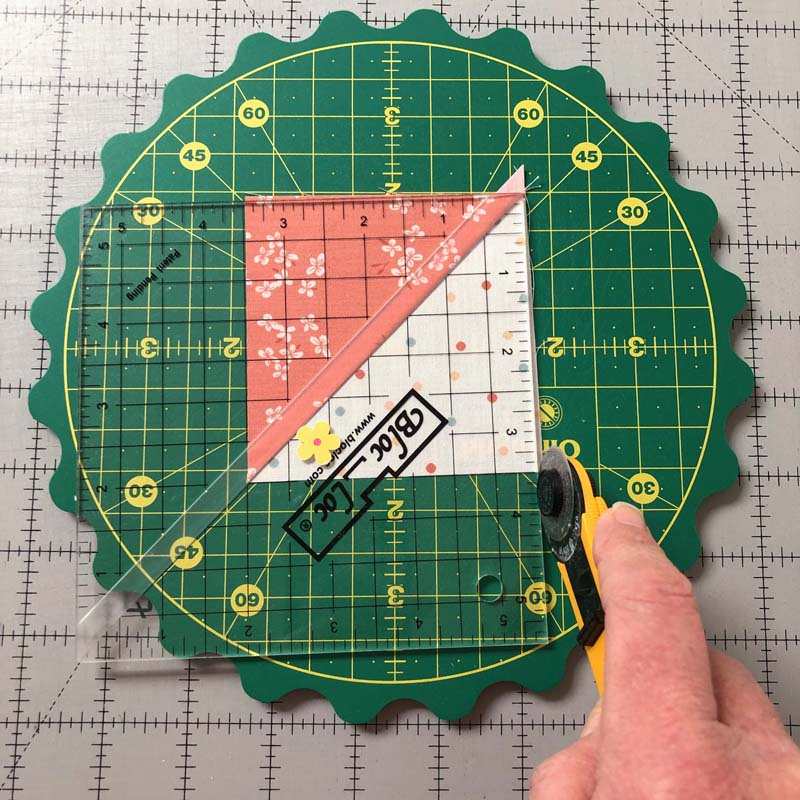 The Omnigrid Rotating Mat with Scalloped Edges is perfect for trimming HST's (half-square triangle units).