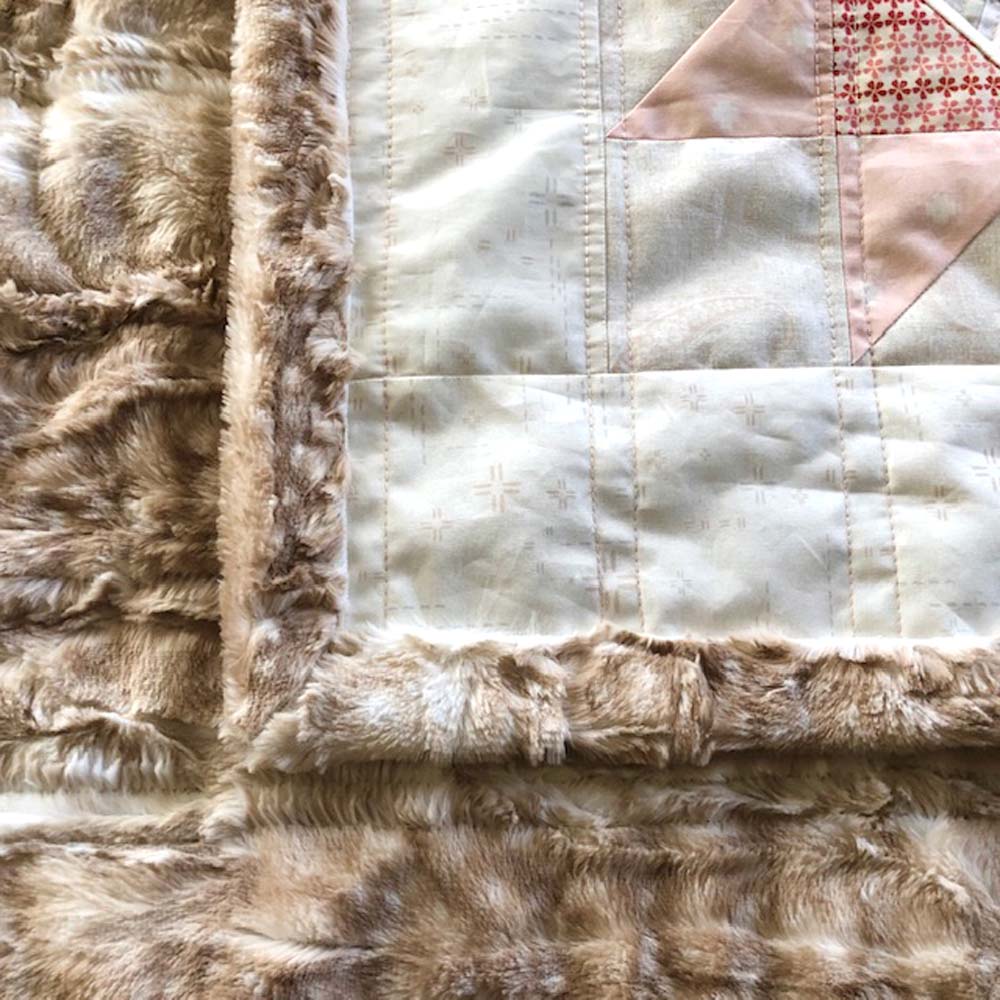 My experience and best tips for using Cuddle minky fabric for backing & binding on quilt @ The Crafty Quilter. This Arrow Stone quilt has self-binding from the backing fabric.