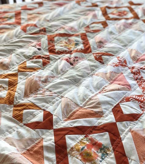 Scrappy Arrow Stone Quilt with straight line quilting (and a few ripples). 