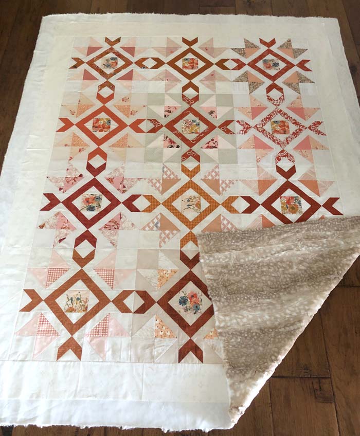 Scrappy Arrow Stone quilt designed and made by Julie Cefalu @ The Crafty Quilter (in the basting stage). Backing is Cuddle Luxe Fawn by Shannon Fabrics.