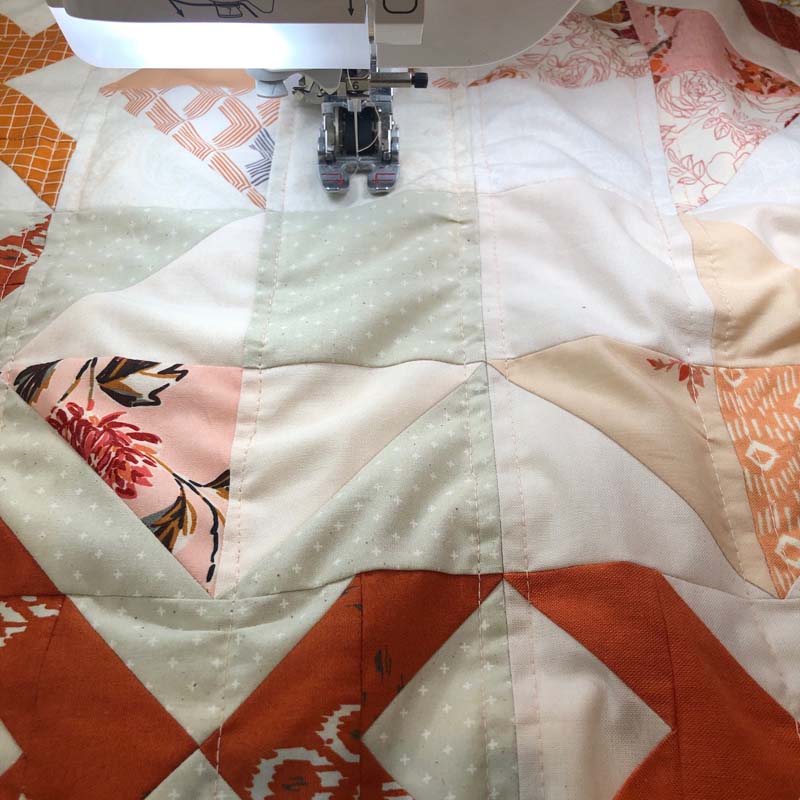 Machine quilting my Scrappy Arrow Stone Quilt @ The Crafty Quilter