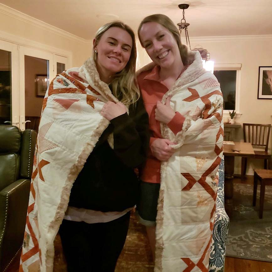 Our friend Mary and my daughter Sara wrapped in a quilt backed with Cuddle Minky Luxe fabric.