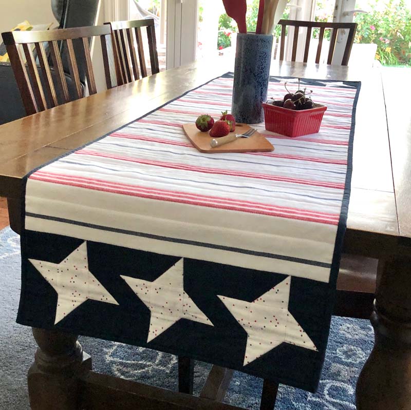 Summer quilt projects include this Patriotic table runner made by Cindy Finn, using 60" wide toweling by Moda Fabrics.