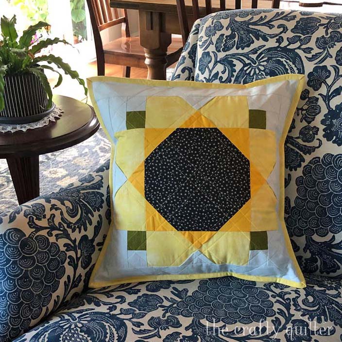 Turn a Garden Sunflower quilt block into a pillow easily! Free block instructions available at The Crafty Quilter.