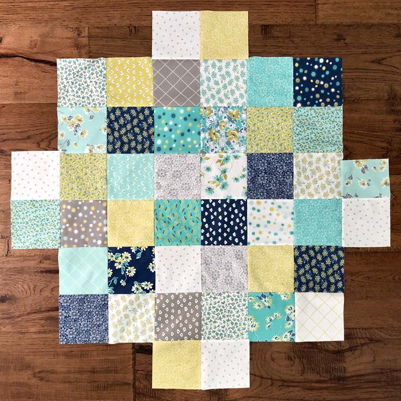 Sterling Table Topper quilt back made from charm squares.