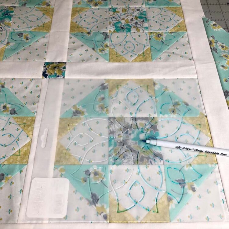 Using stencils to mark a quilt top.
