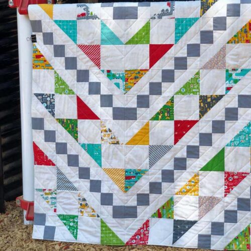 Straight line quilting is an easy finish for this Bowtie quilt made by Julie Cefalu from the book Just One Charm Pack Quilts by Cheryl Brickey.