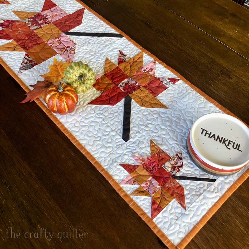 Scrappy Leaves Table Runner is a perfect way to decorate for Fall. Free pattern is available @ The Crafty Quilter.