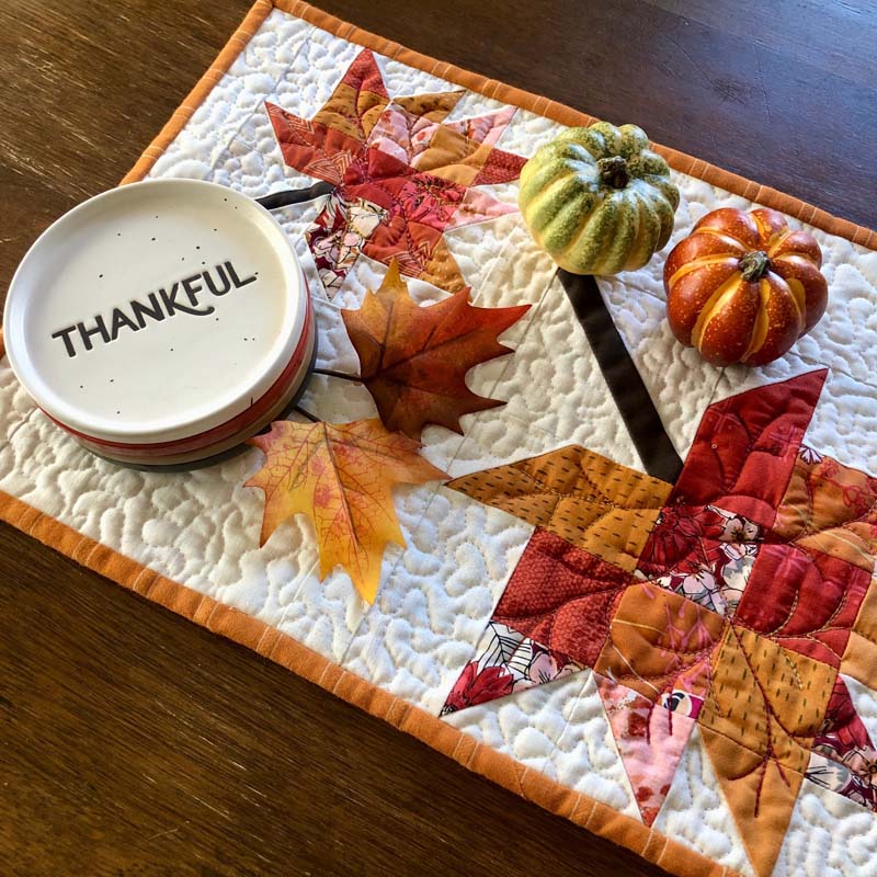 Scrappy Leaves Table Runner is a perfect way to decorate for Fall. Free pattern is available @ The Crafty Quilter.