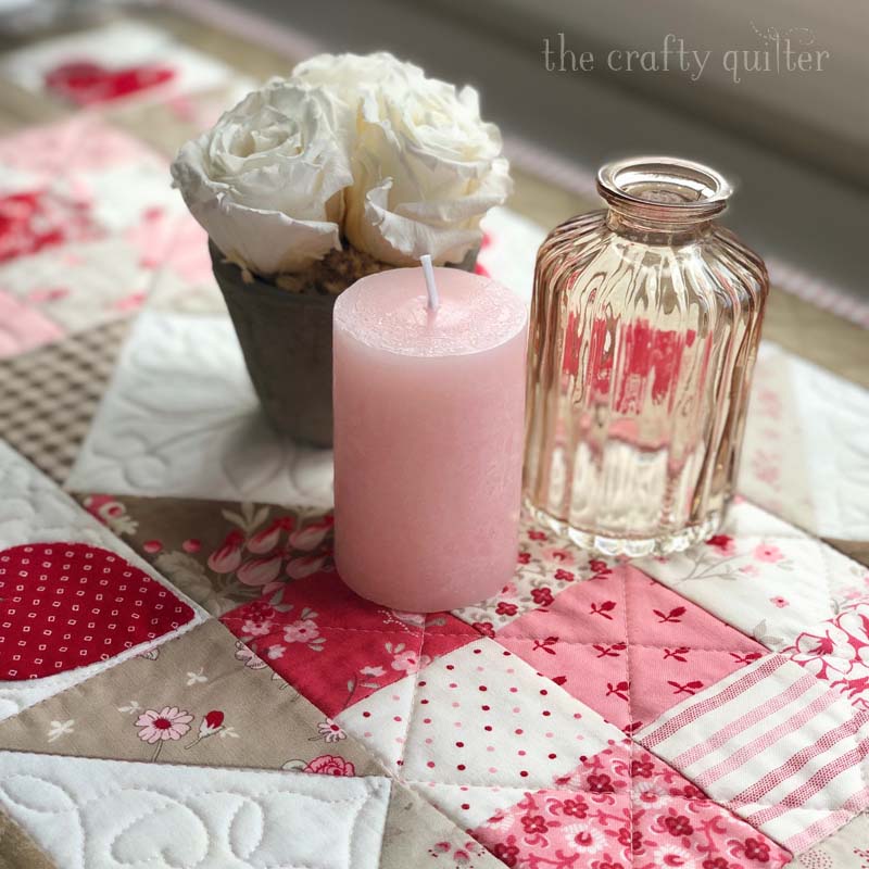 This Valentine's Day Table Runner is so sweet and fun to make!  I used my free Vintage Heart Quilt block tutorial to make the blocks for this one.