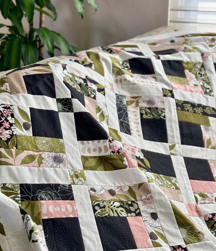 Jelly Roll Cabin quilt draped over the sofa.