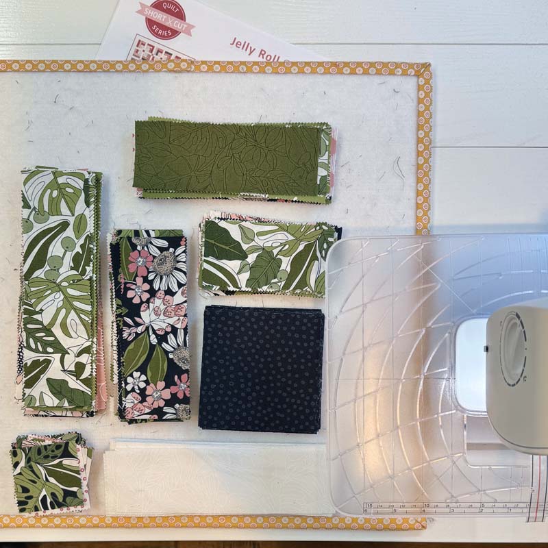 Cut pieces stacked next to the sewing machine and ready to sew.