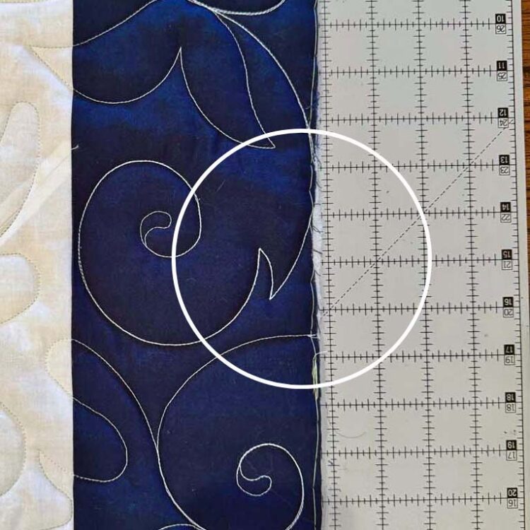Batting that peeks out of the trimmed edge will be hidden inside the binding seam.