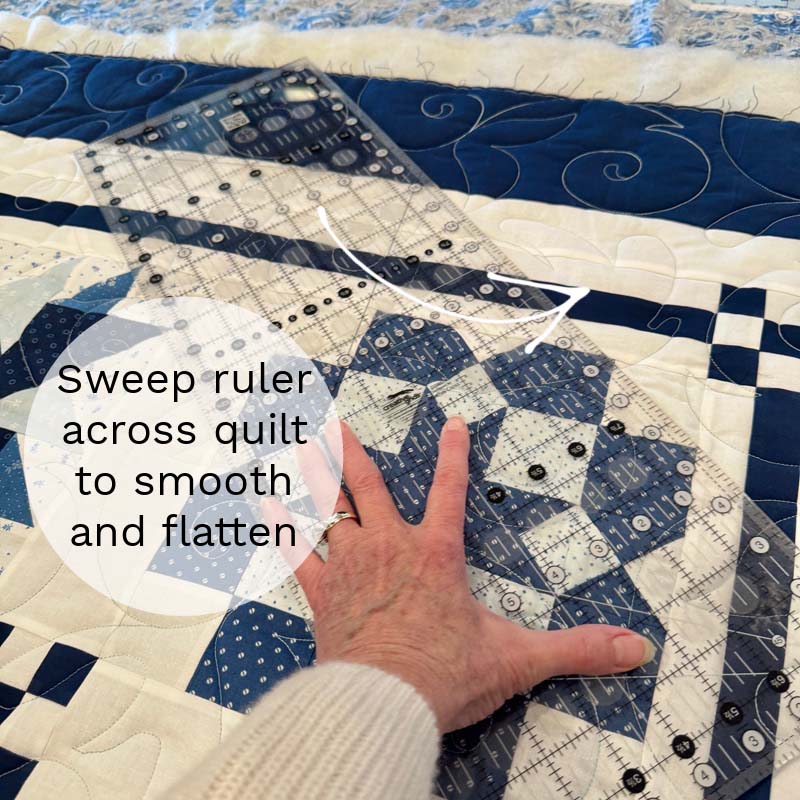 Sweep a ruler across the quilt helps to smooth and flatten it.