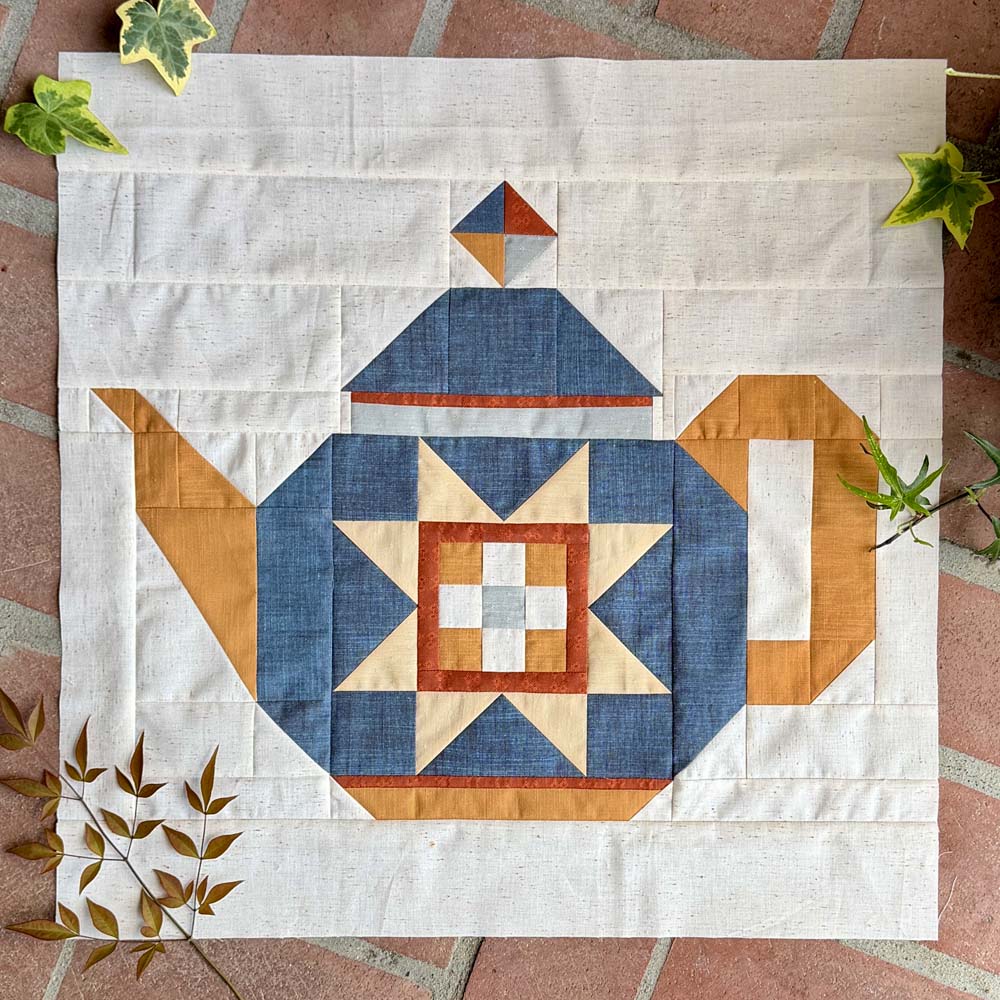 The Collective Kettle quilt block made by Julie is shown