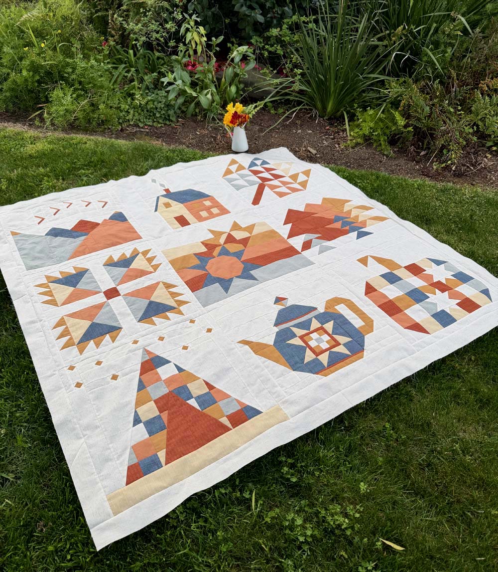 My Sweater Weather quilt on the grass in my front yard.