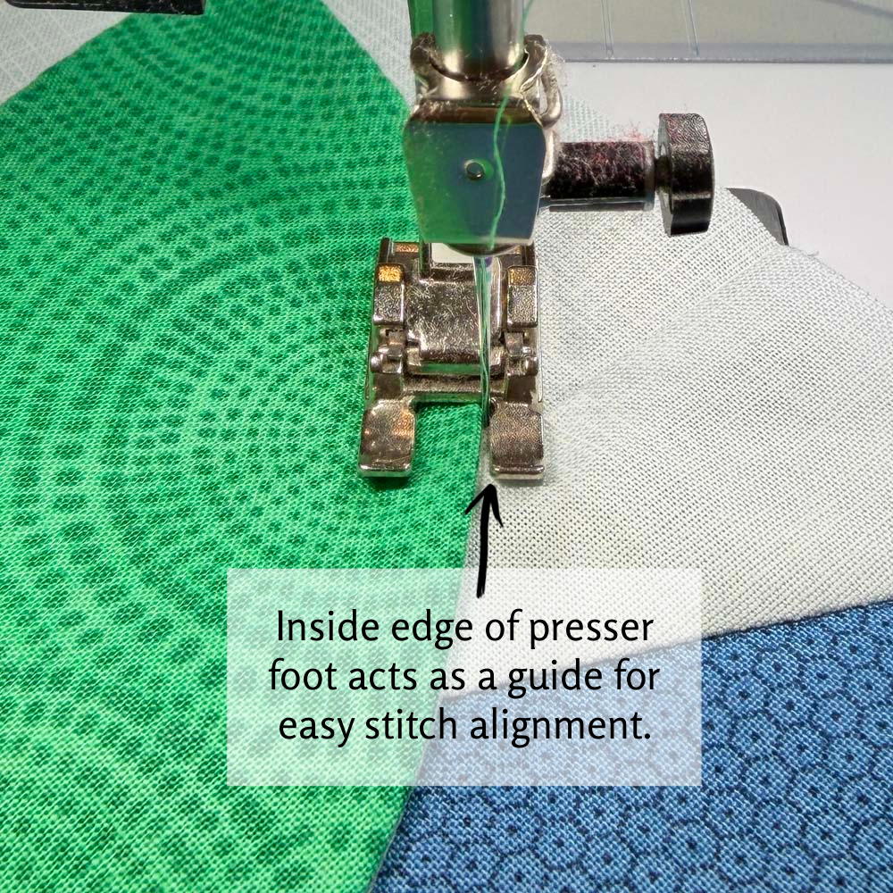 Using the presser foot as a guide for machine applique stitch placement.